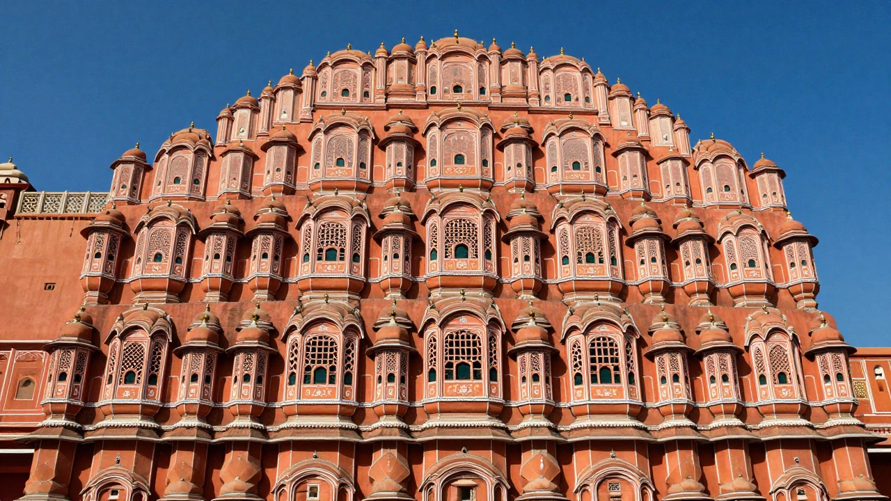 The terracotta-pink facade of the Hawa Mahal in Jaipur under a bright sky